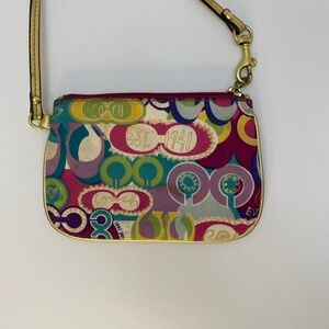 Multi colored Coach wristlet with gold trim